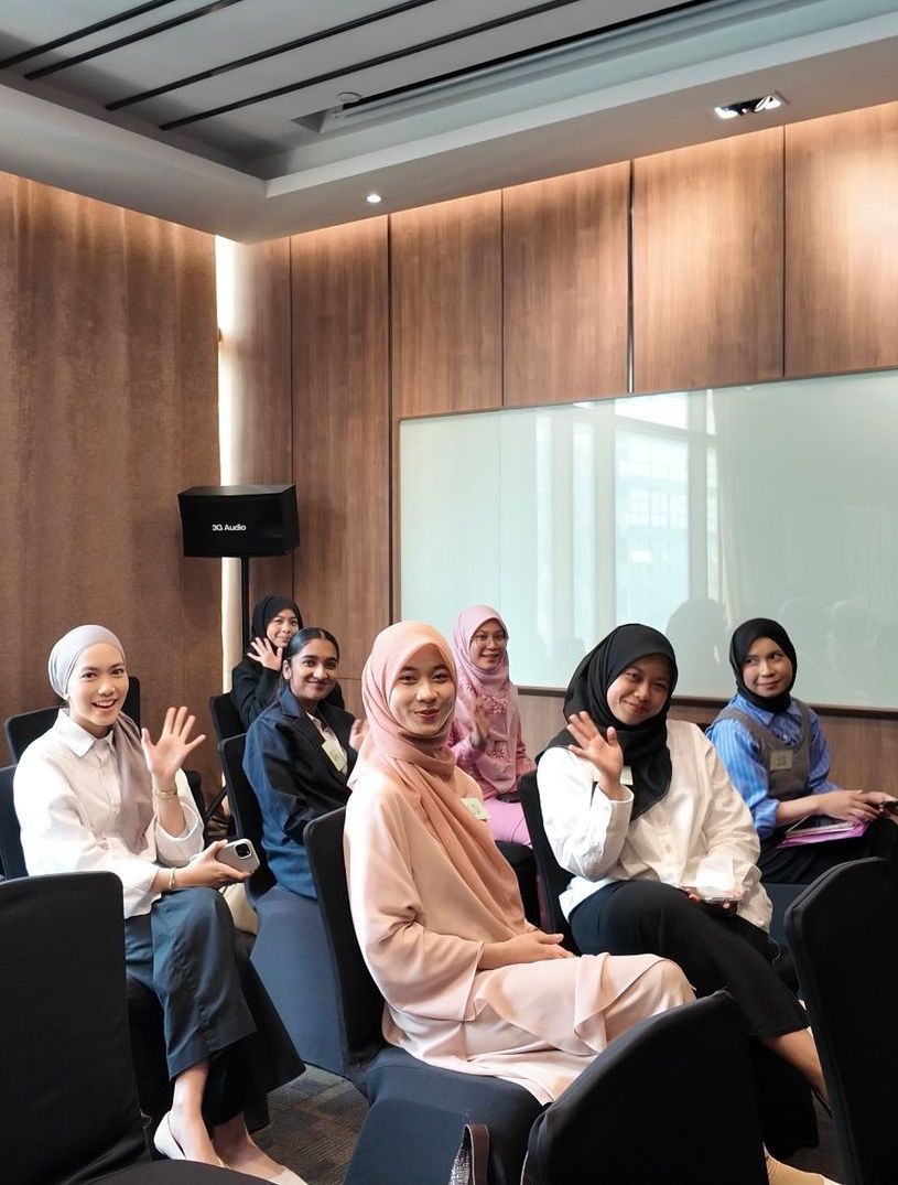 A group of women are sitting in chairs in a room.