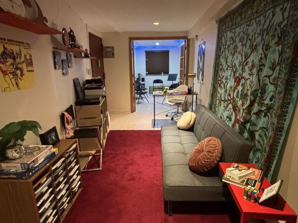 A living room with a couch and a rug