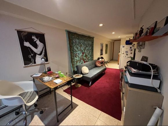 A living room with a couch and a desk