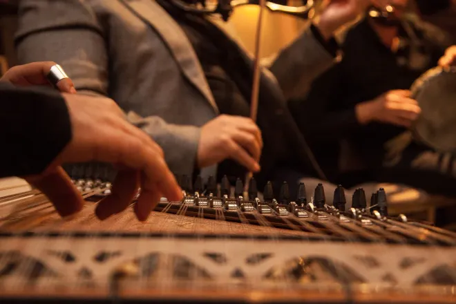 A close up of a person playing a musical instrument.