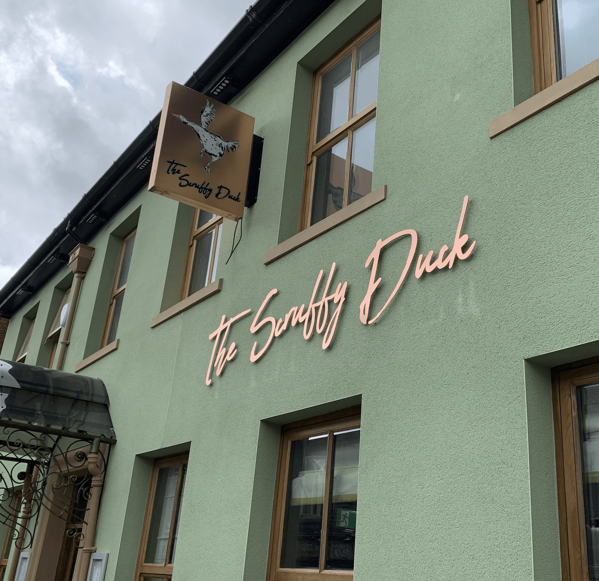 Fret cut projecting sign with laser cut lettering mounted with stand off fixings