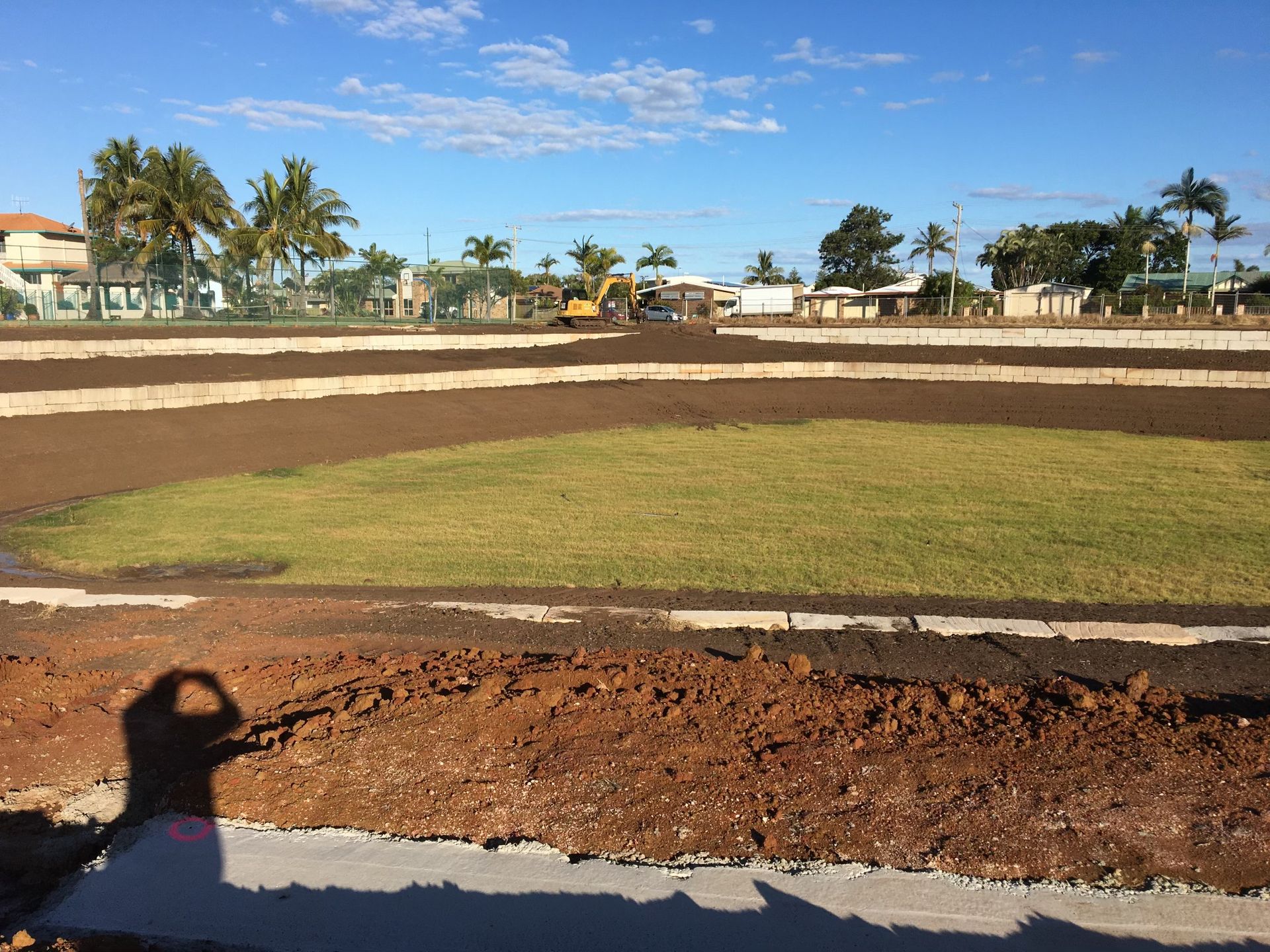 A Field with Tiers of Dirt and Grass, Construction Equipment — A1 Rock This City Truck & Dog Hire In Good Night, QLD