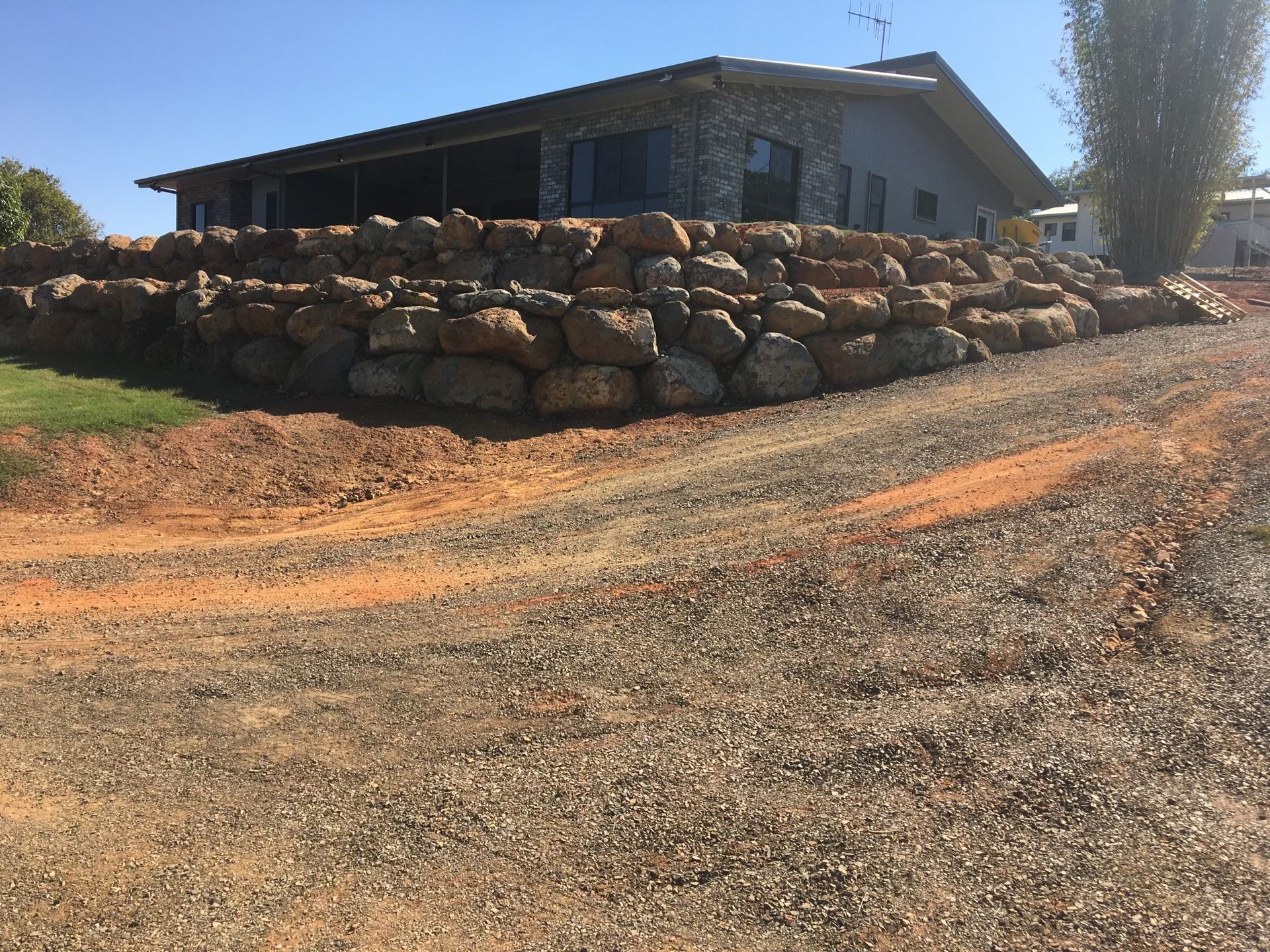 Stone Retaining Wall in Front of A House — A1 Rock This City Truck & Dog Hire In Good Night, QLD