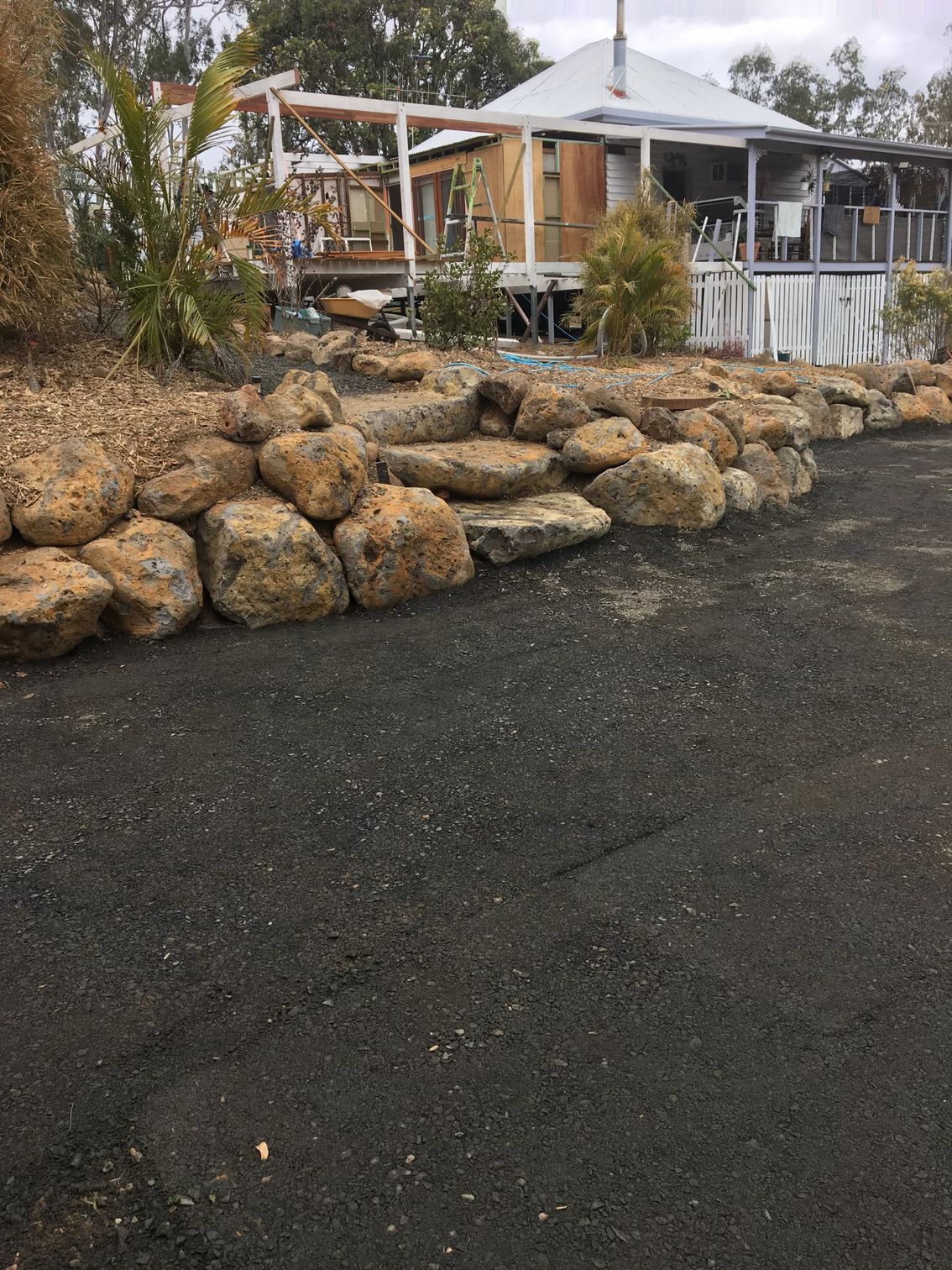 Rock Retaining Wall in Front of A House — A1 Rock This City Truck & Dog Hire In Good Night, QLD