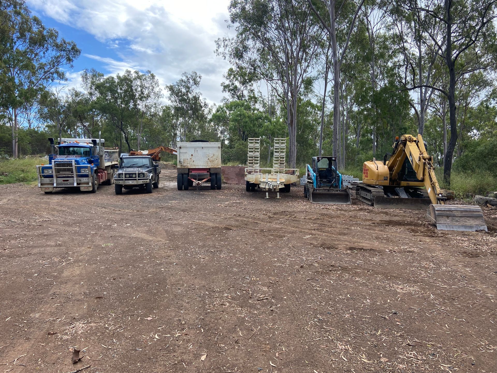 Several Construction Vehicles Parked on A Dirt — A1 Rock This City Truck & Dog Hire In Good Night, QLD
