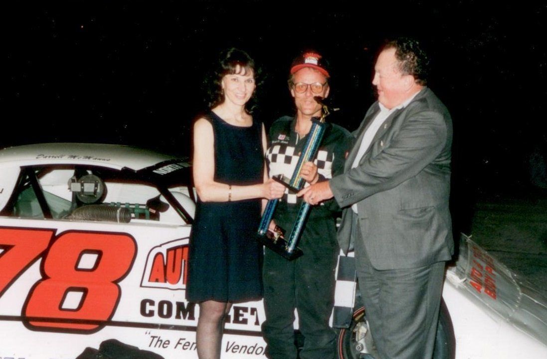 handing a trophy at a motor sports race