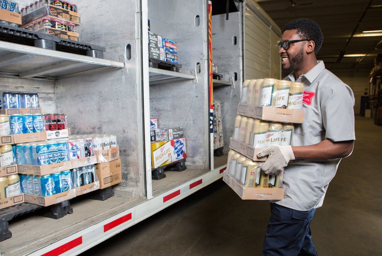 man loading beer onto a truck