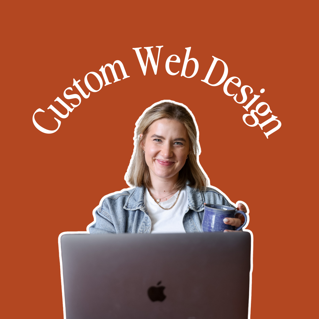 Woman on a burnt-orange couch using a laptop, holding a mug. Surrounded by framed art.