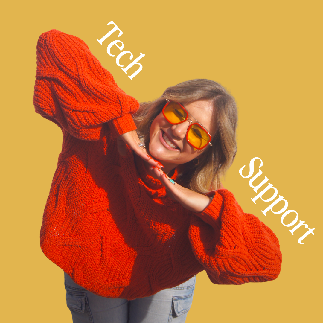 Person in red sweater holds a phone, red nails, rings.