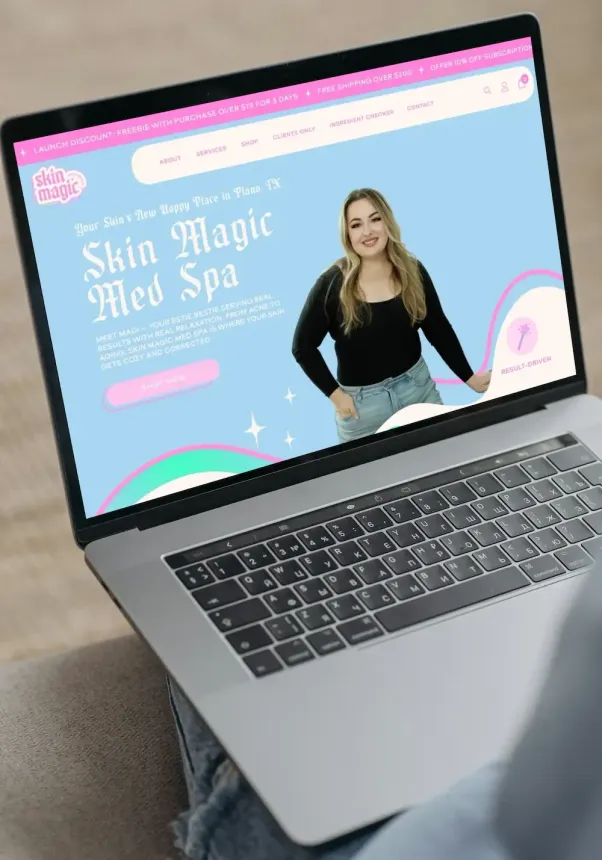 Laptop displaying a pastel website for a spa with a woman and the text “Skin Magic Med Spa”