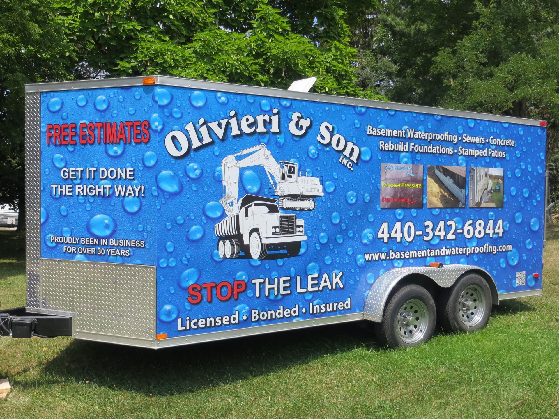 Blue trailer for Olivieri & Son, a leak repair service, with contact info & an image of a vehicle.