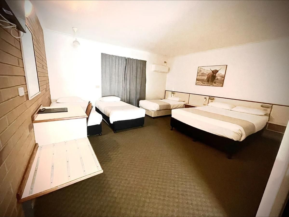 Interior of a Motel Room With Two Beds and a Desk — Country Comfort Gin Gin Wild Scotsman Motor Inn in Gin Gin, QLD