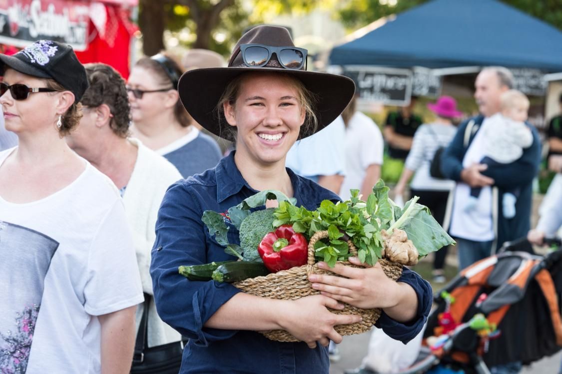 A Woman in a Hat is Holding a Basket of Vegetables — Country Comfort Gin Gin Wild Scotsman Motor Inn in Gin Gin, QLD