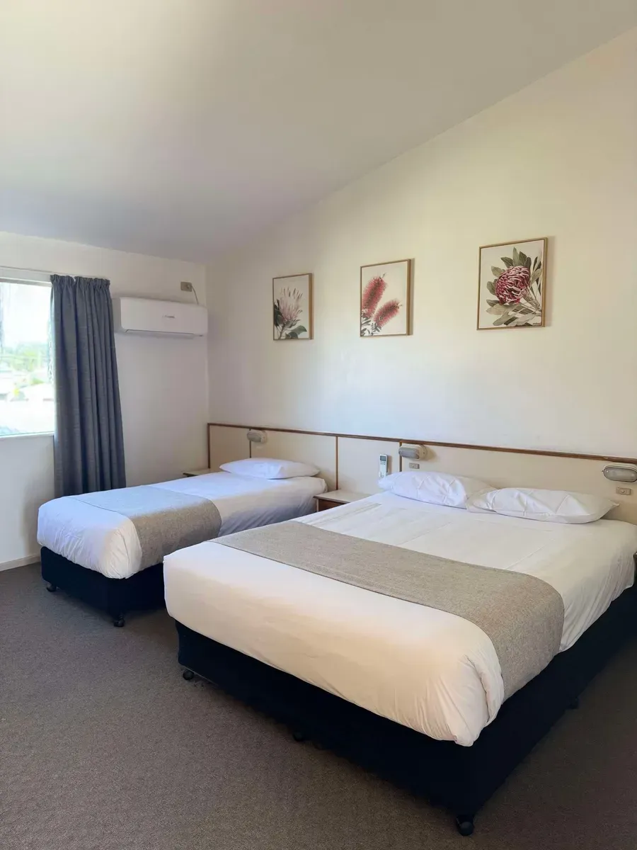 Two Beds With White Sheets Are Arranged in a Room Featuring a Window That Lets in Natural Light — Country Comfort Gin Gin Wild Scotsman Motor Inn in Gin Gin, QLD