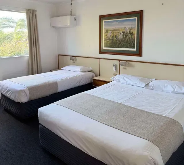 A Hotel Room With Two Beds and a Picture on the Wall — Country Comfort Gin Gin Wild Scotsman Motor Inn in Gin Gin, QLD