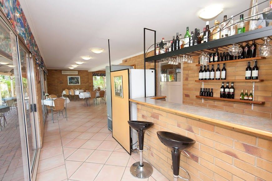 A Bar With a Lot of Bottles of Alcohol on It — Country Comfort Gin Gin Wild Scotsman Motor Inn in Gin Gin, QLD