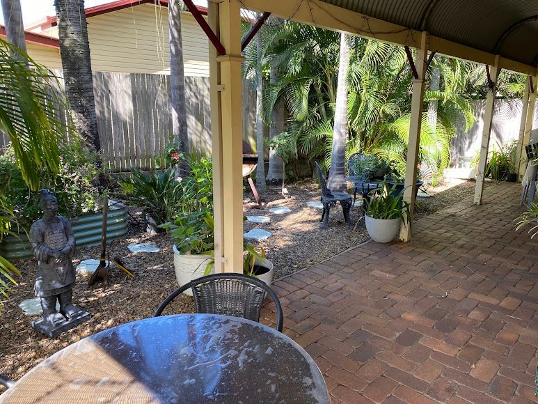 A Patio With a Table and Chairs Under a Canopy — Country Comfort Gin Gin Wild Scotsman Motor Inn in Gin Gin, QLD