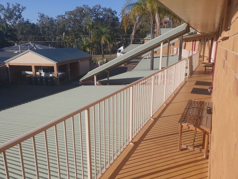 A Balcony With a White Railing and a Bench — Country Comfort Gin Gin Wild Scotsman Motor Inn in Gin Gin, QLD