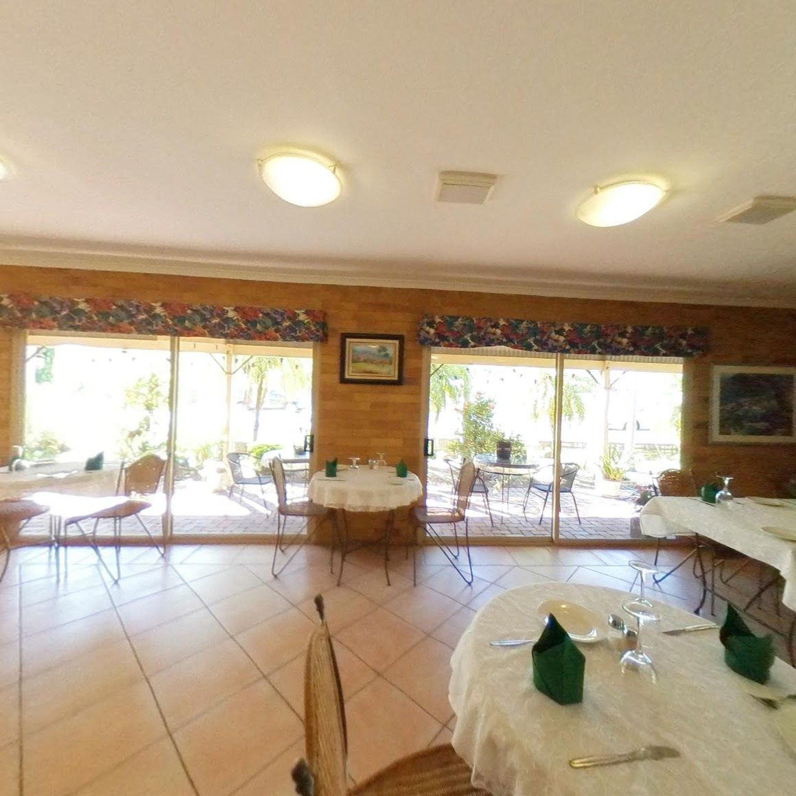 A Restaurant With Tables and Chairs and a Large Window — Country Comfort Gin Gin Wild Scotsman Motor Inn in Gin Gin, QLD