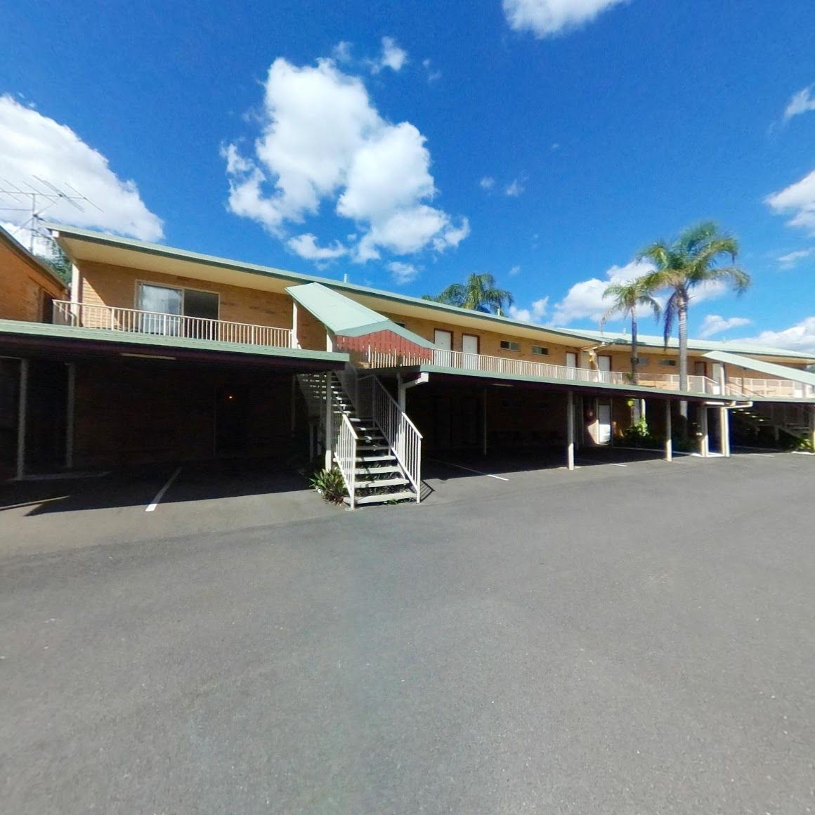 A Large Building With Stairs Leading Up to It — Country Comfort Gin Gin Wild Scotsman Motor Inn in Gin Gin, QLD
