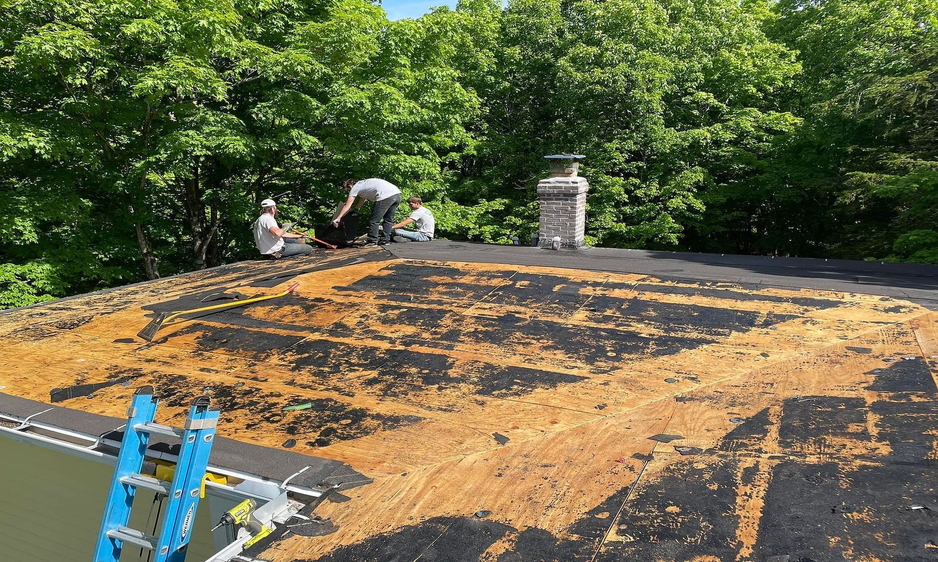 A group of people are working on a roof.