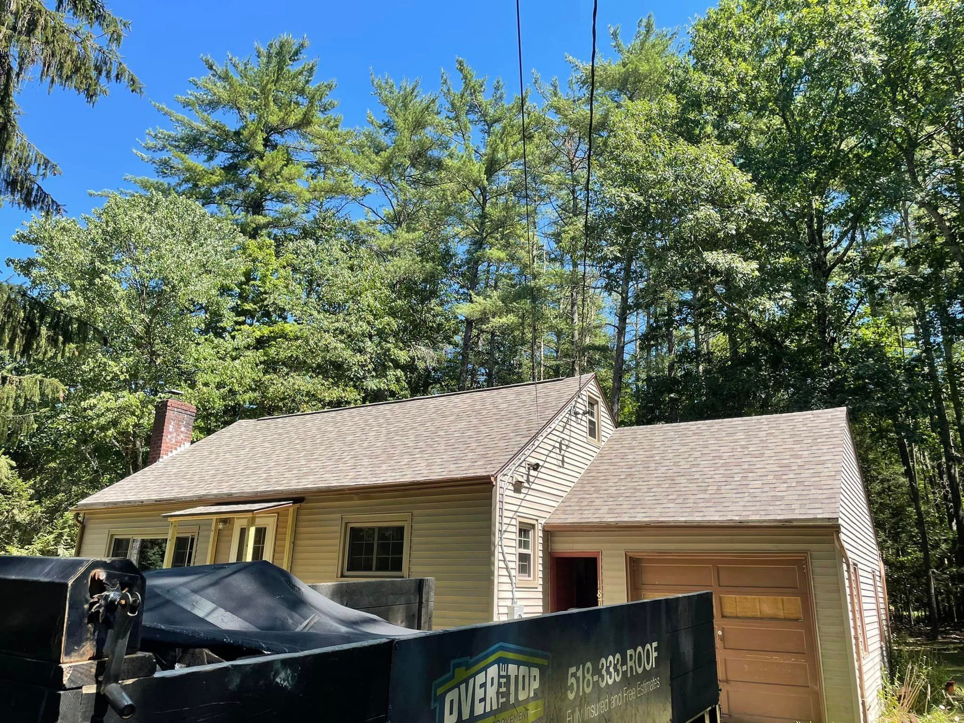 A truck is parked in front of a house that is being remodeled.