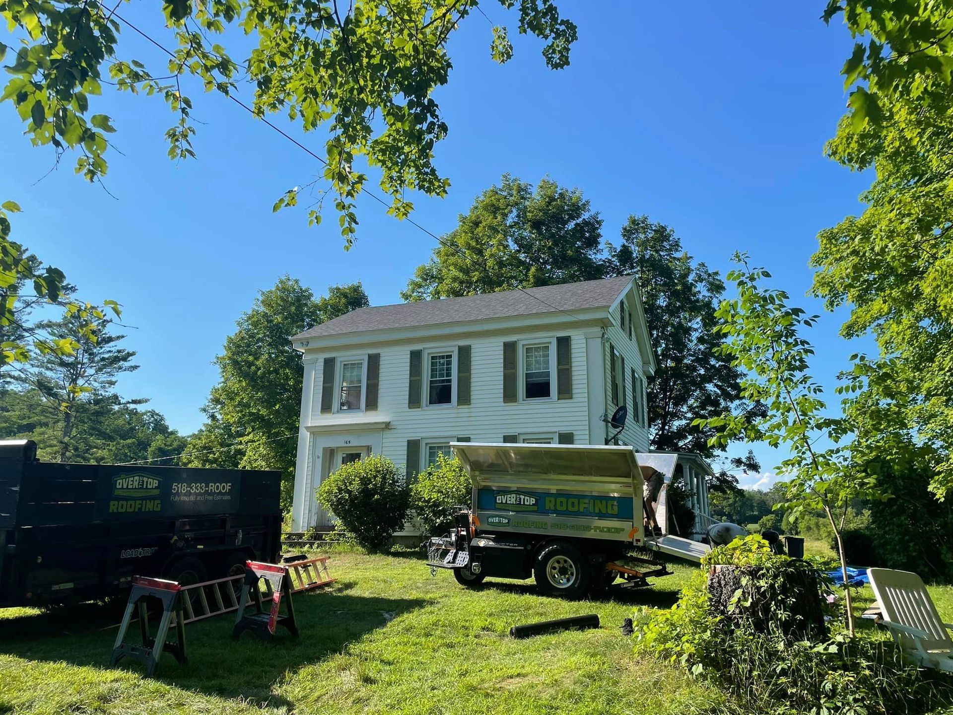 A dump truck is parked in front of a house.