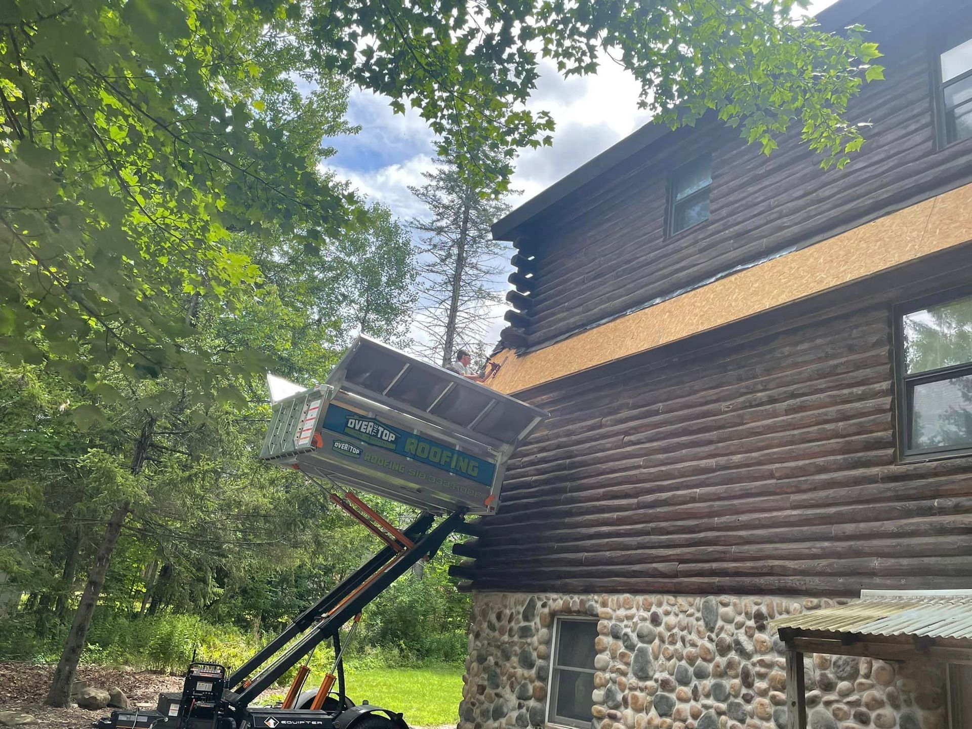 A wooden house with a truck parked in front of it.