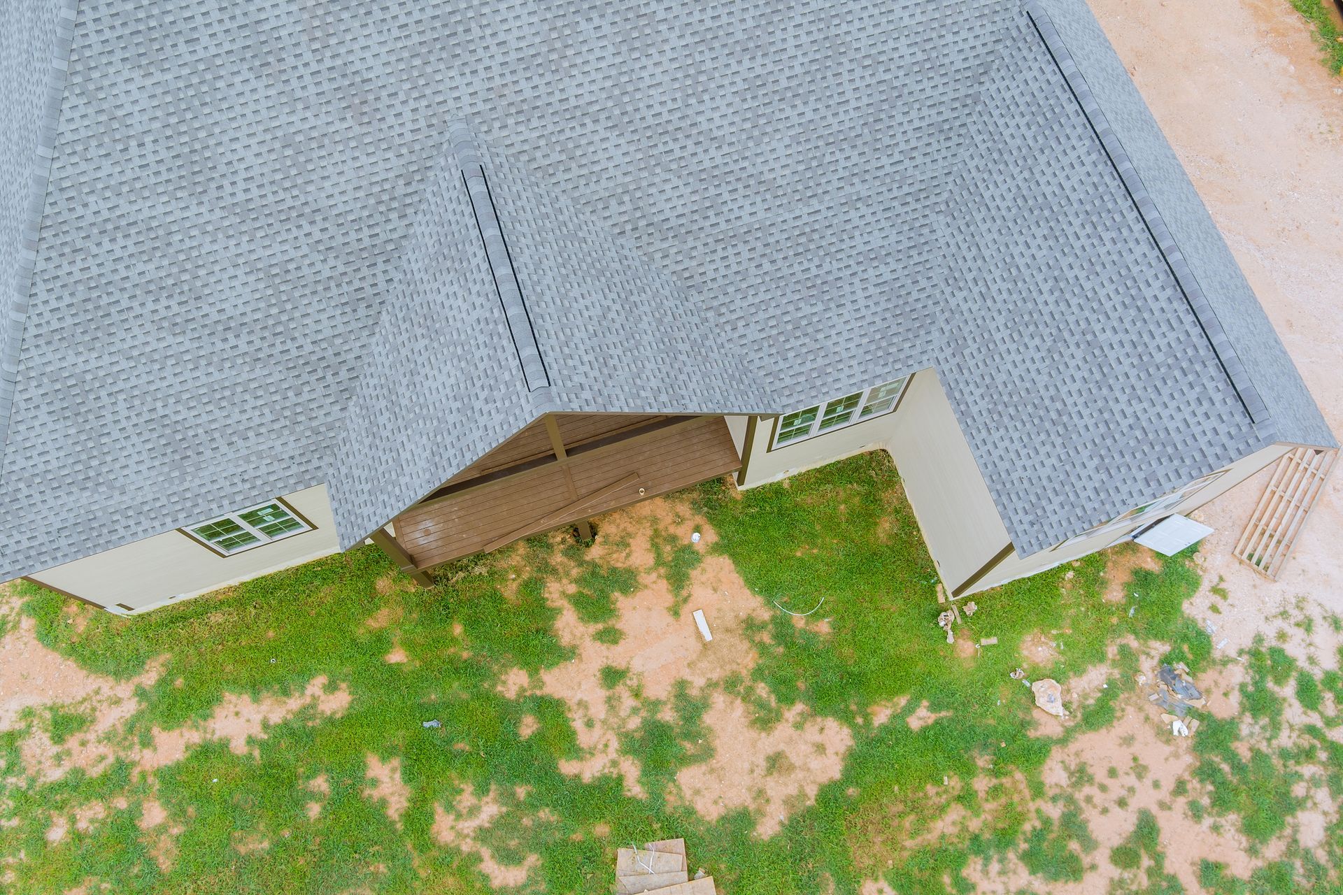 An aerial view of a house with a roof that is covered in shingles.