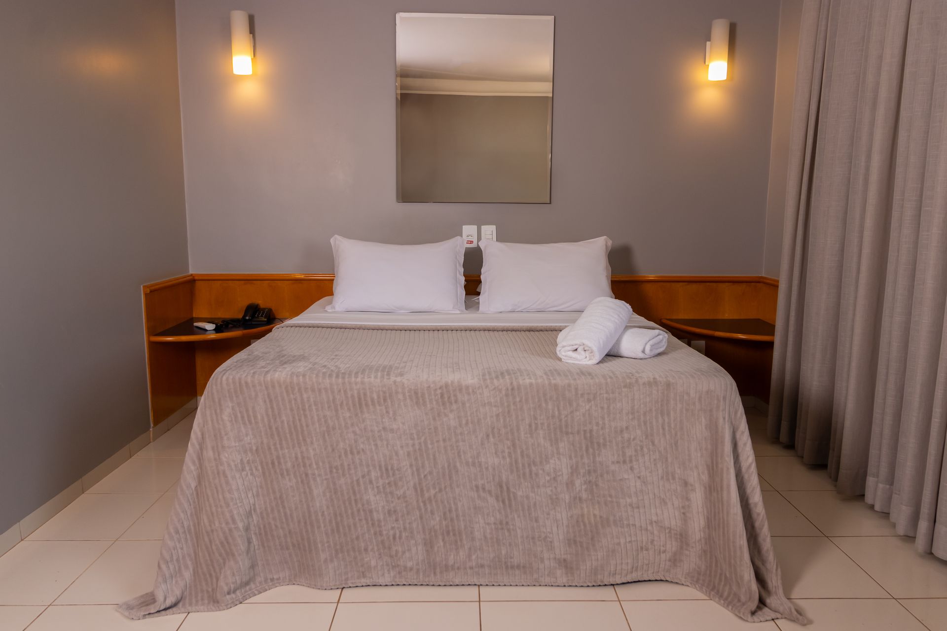Um quarto de hotel com uma cama grande e um banheiro.