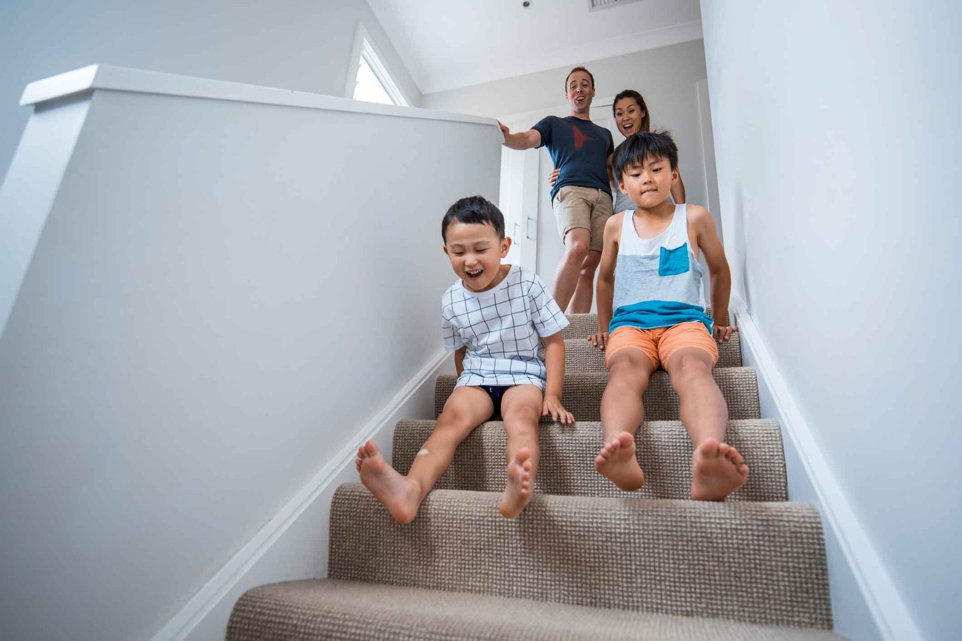 A family is sitting on a set of stairs.