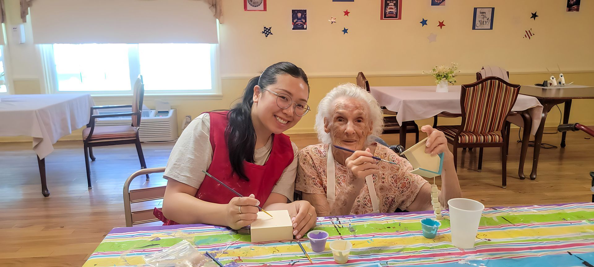 Caregiver assisting a resident during an activity at Newburgh Health and Rehab