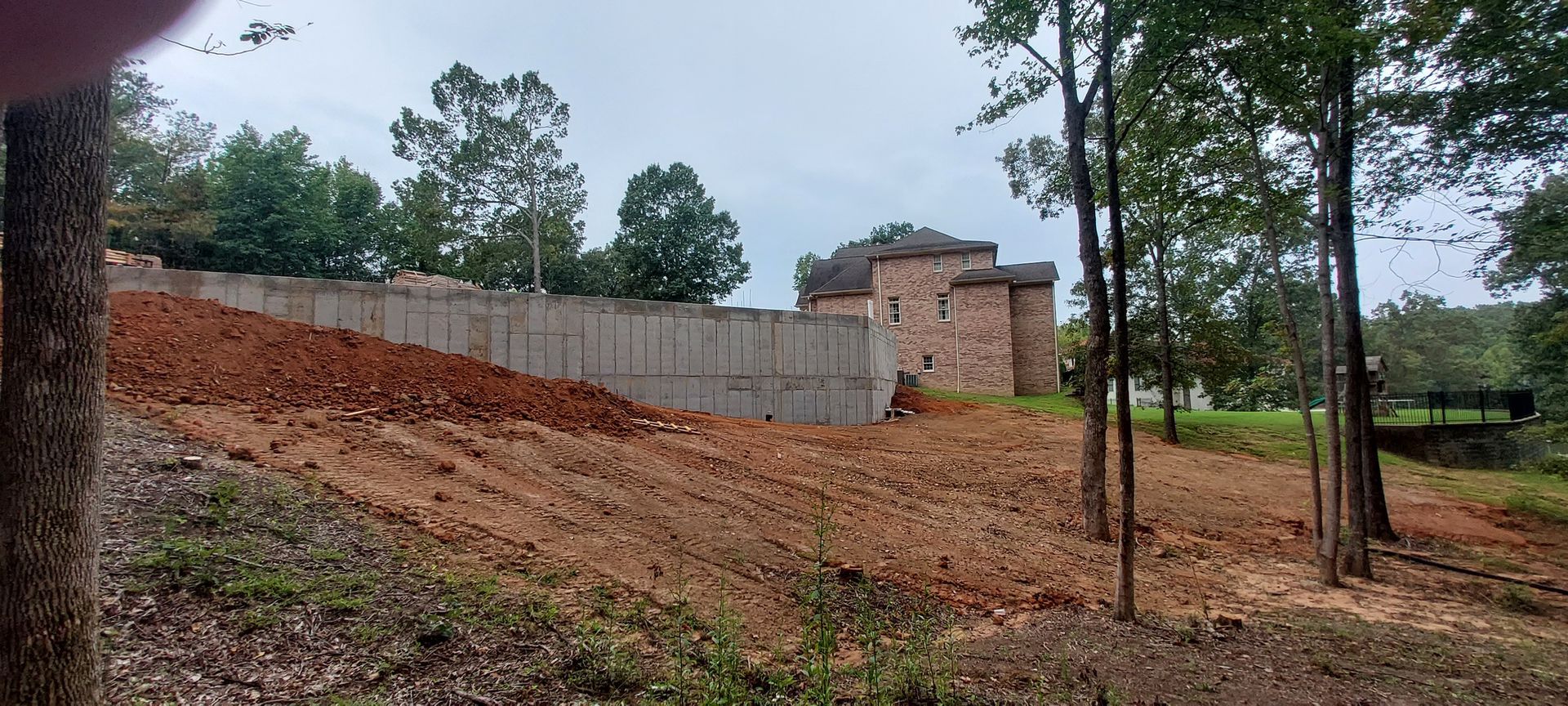 A house is being built on a hill in the middle of a forest.