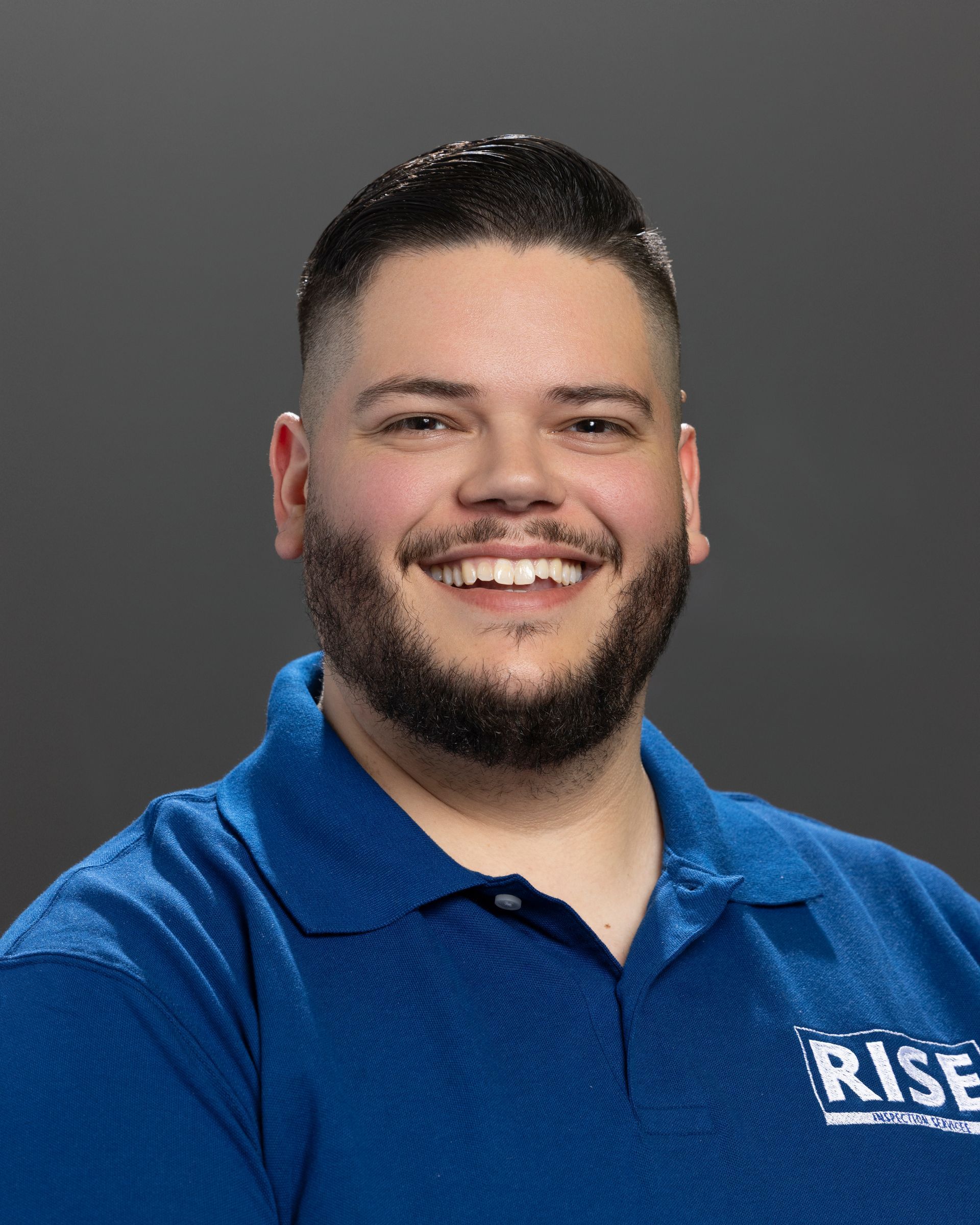A man in a suit and tie is smiling for the camera.