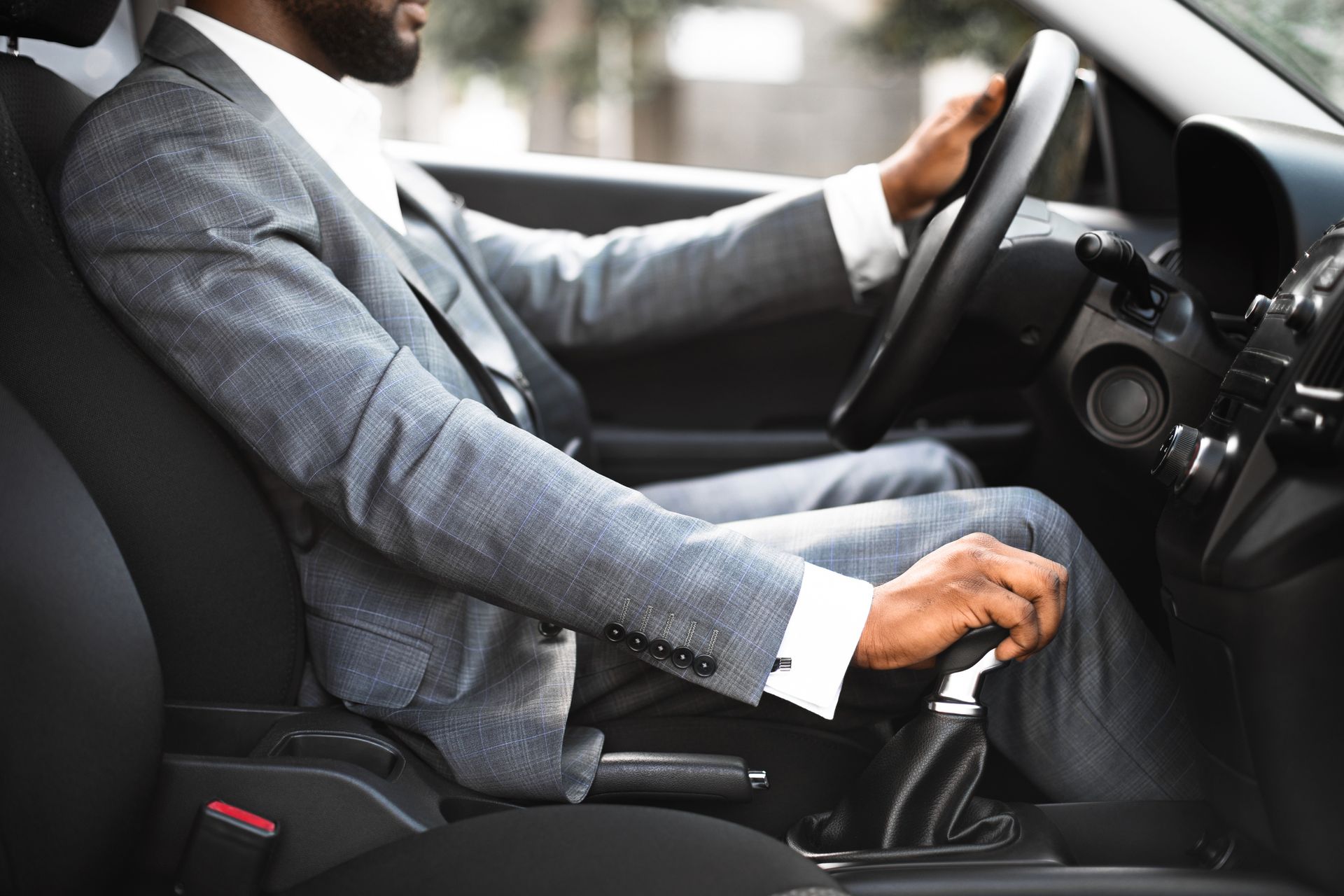 Man in a Suit is Driving a Car — Norfolk, VA — Opulence Transportation LLC Man in a Suit Driving a Car — Norfolk, VA — Opulence Transportation LLC