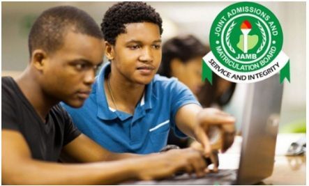 Two students using laptops in a computer lab, with a green Joint Admissions and Matriculation Board logo.