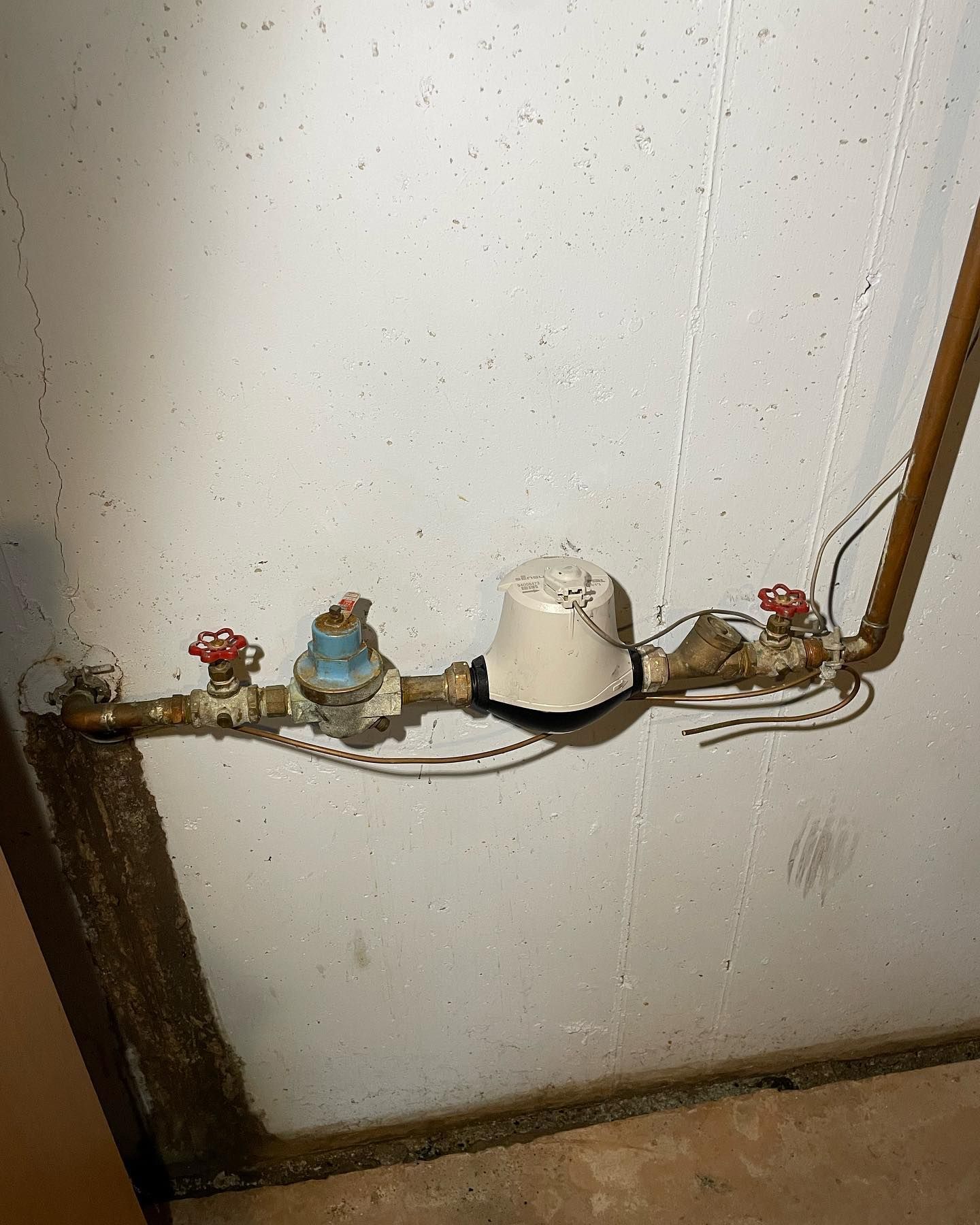 a water meter is attached to a copper pipe