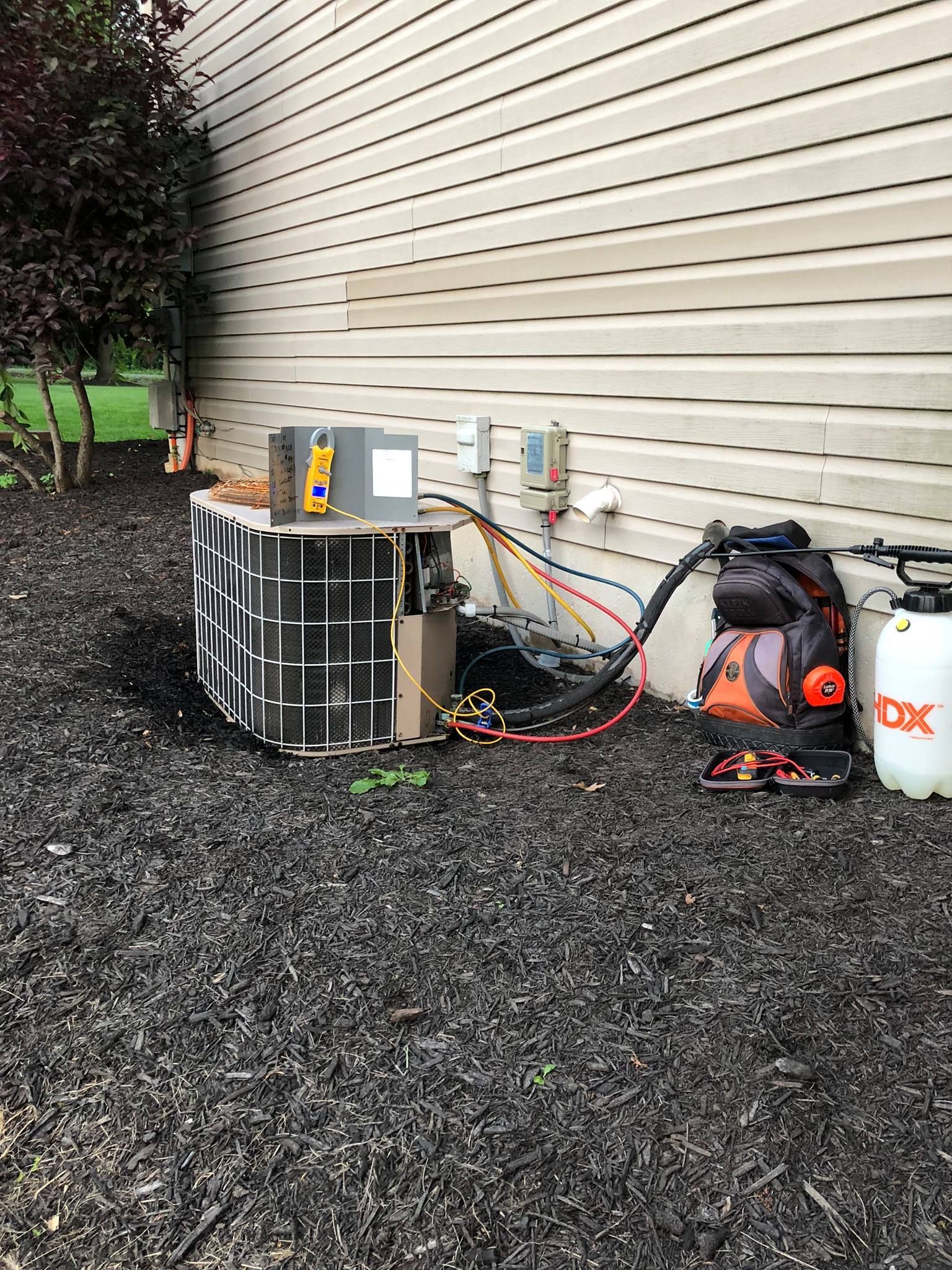 a dx backpack sits next to an air conditioner