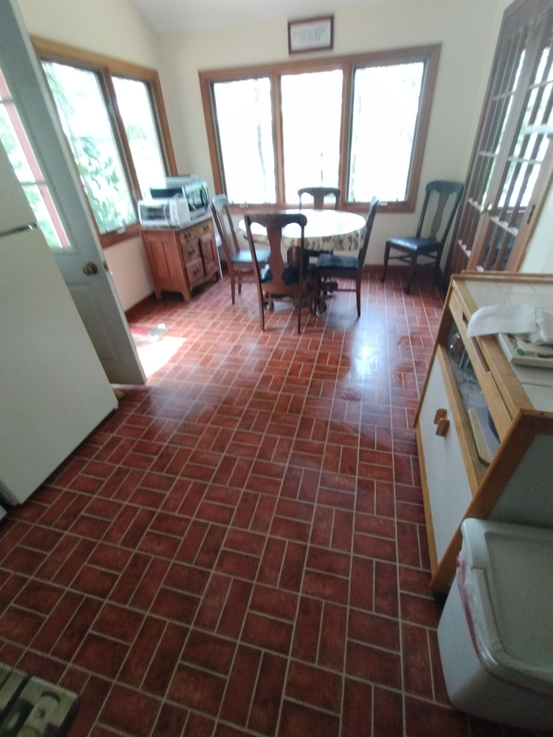 A kitchen with a table and chairs in it