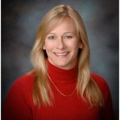 Rene Hohls wearing red turtleneck