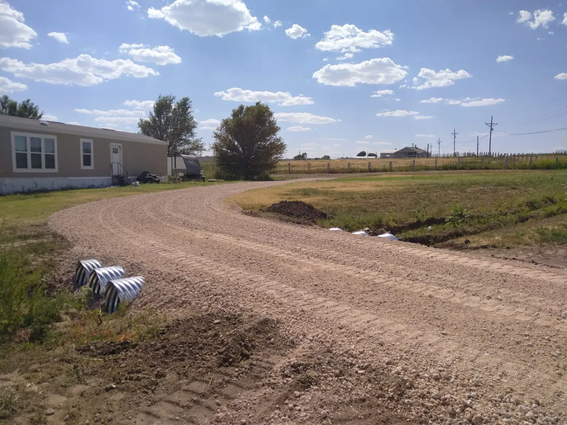 Triple pipe culvert for heavy rains in front of home. 