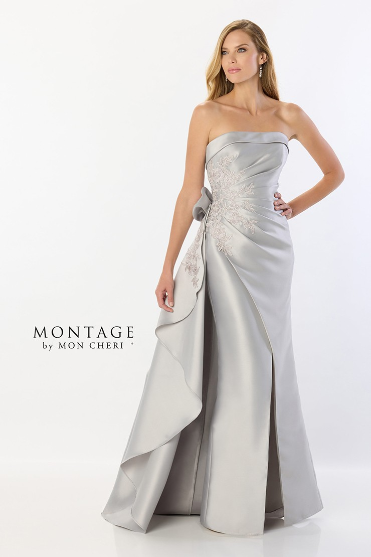 Woman in silver strapless gown with embroidered bodice and side slit, posing.