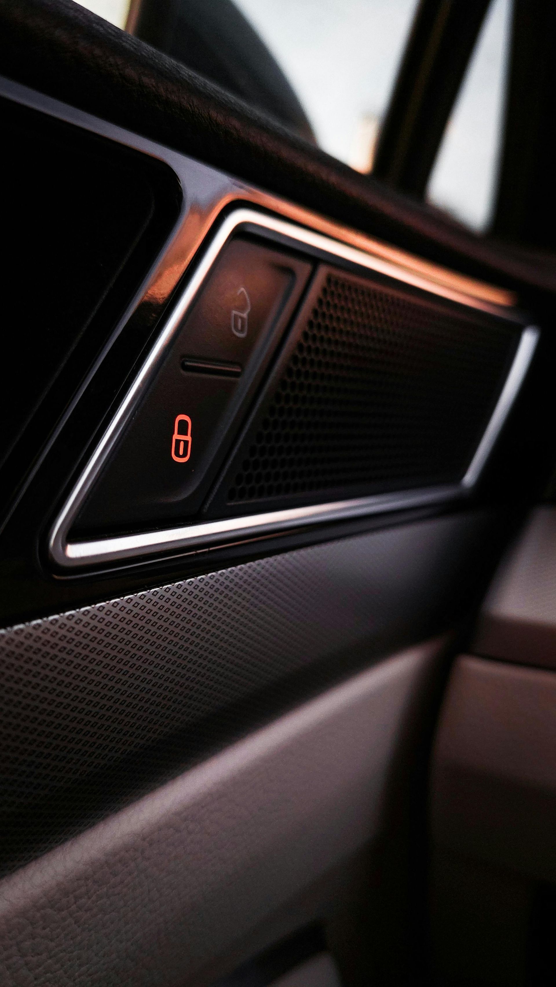 A close up of a car door with a speaker on it.