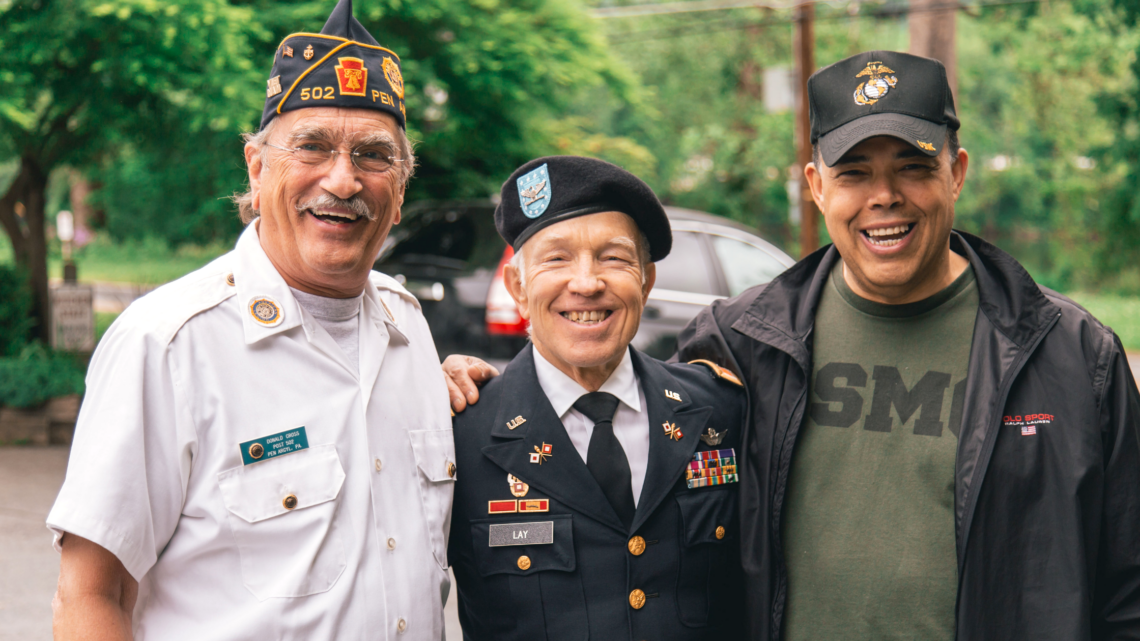 Three men in military uniforms are posing for a picture.