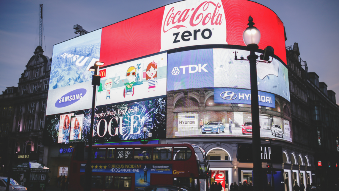 A large billboard on the side of a building that says coca cola zero.