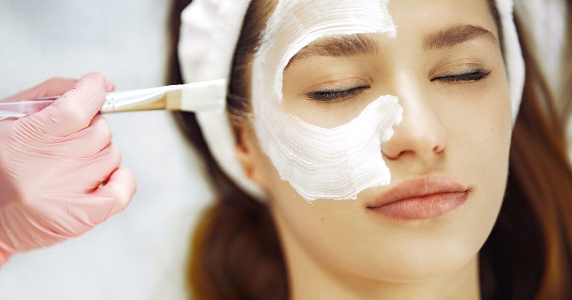 A woman is getting a facial treatment at a spa.