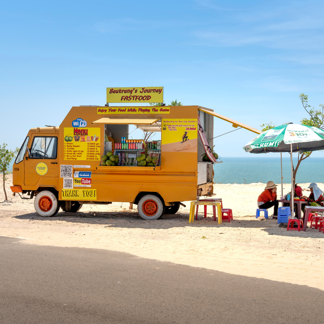 A yellow truck with a sign that says ' aaron 's juicy ' on it