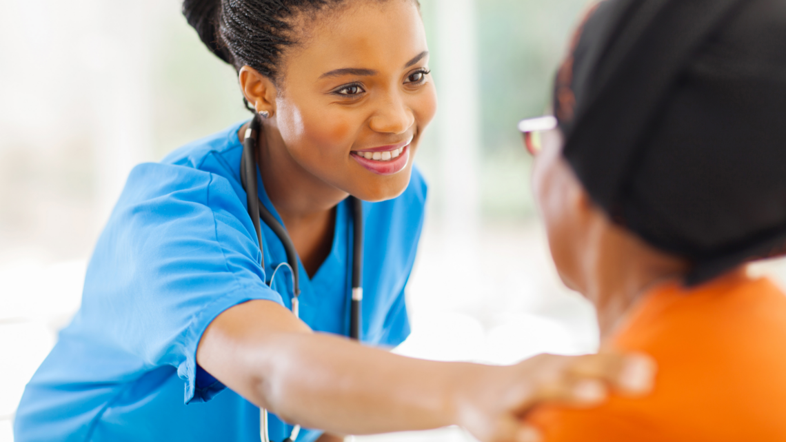 A nurse is holding the arm of an elderly woman.