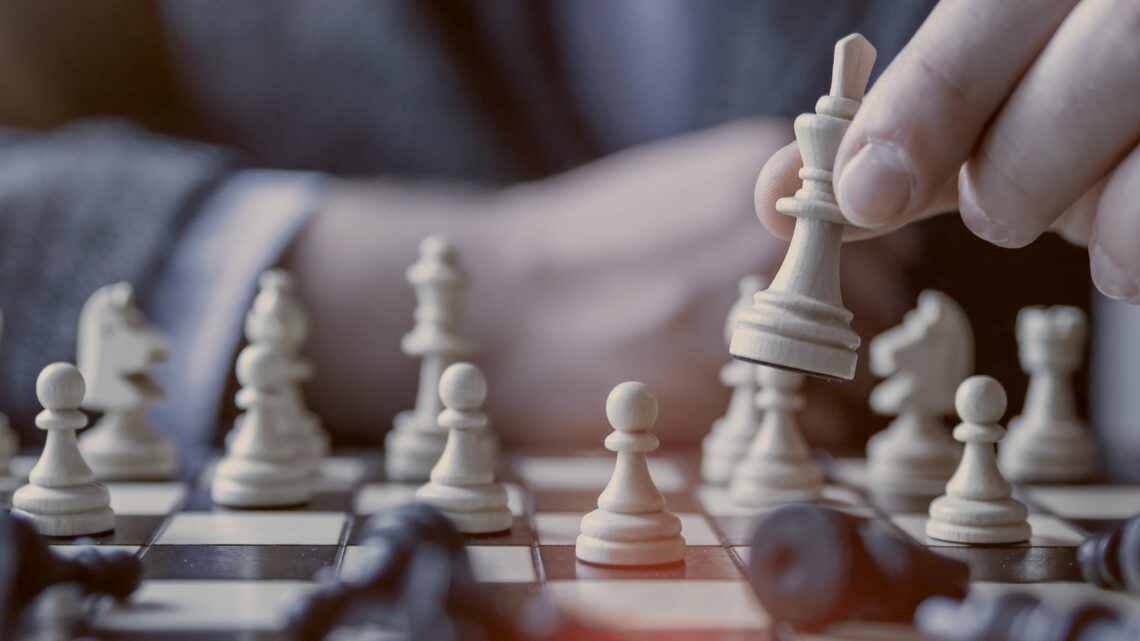 A close up of a person playing a game of chess.