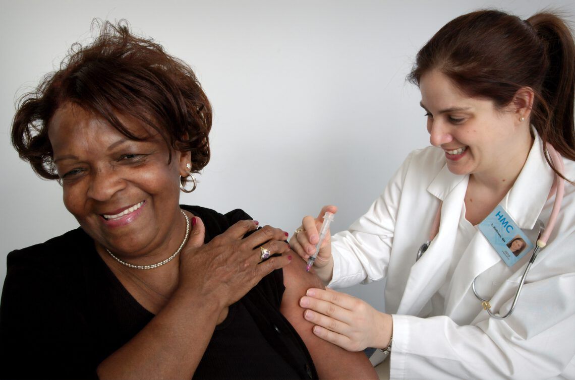 A woman is getting an injection from a doctor